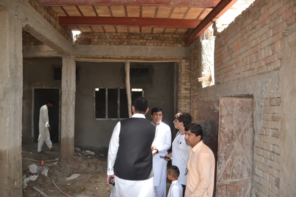 Dilapidated classroom with broken walls and cracked floors in rural Sindh
