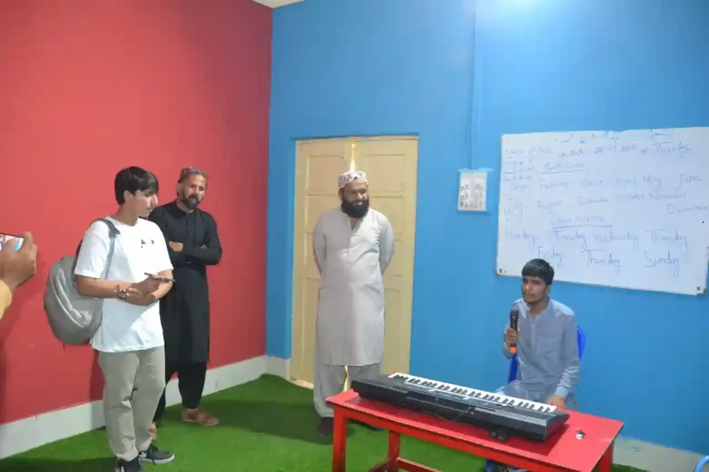 Yahya interacting with students inside a classroom of the Special Education Complex.
