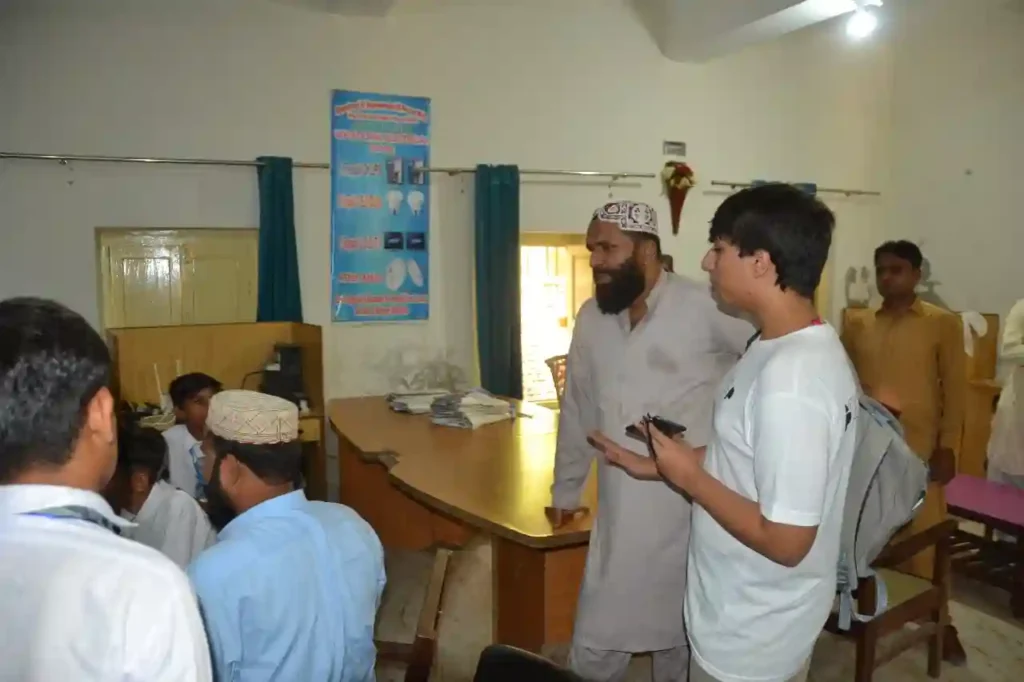 Yahya interacting with students inside a classroom of the Special Education Complex.