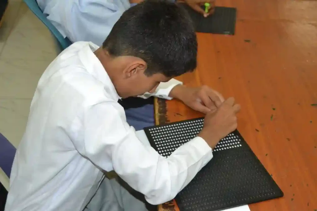 Yahya interacting with students inside a classroom of the Special Education Complex.