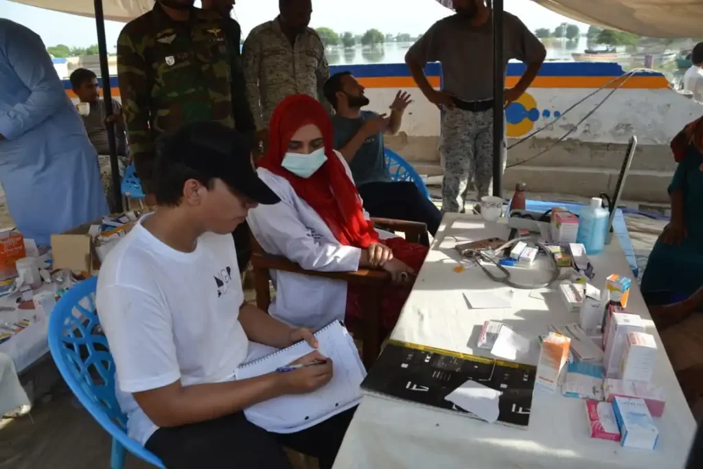 Medical volunteers offer crucial care at a Muzaffargarh flood relief camp.