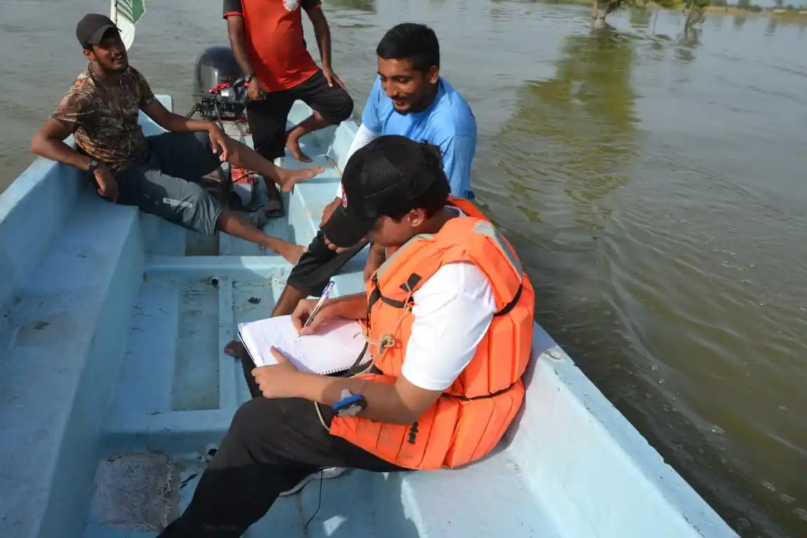 Relief workers deliver food and supplies by boat to stranded families.