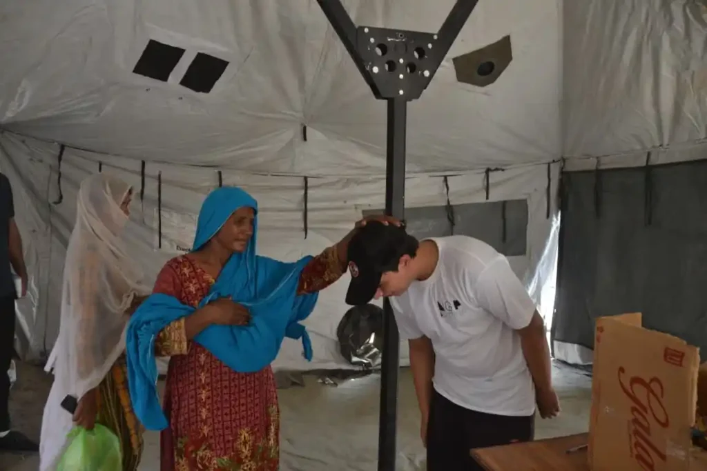 Villagers displaced by floods helping each other in Pakistan.