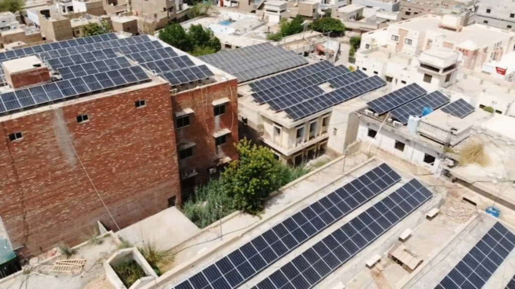 Solar panels generating clean energy in a field, representing Pakistan's efforts in sustainable development and transitioning towards renewable energy sources.